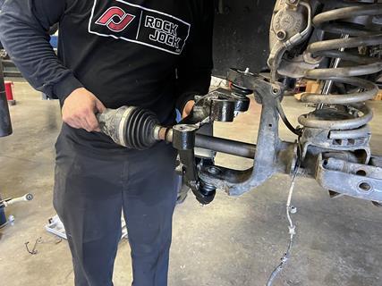 11. Next, the factory CV axle shaft is reinstalled into the axle, through the Rock Jock knuckle