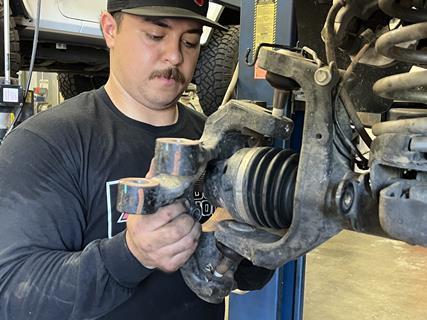 2. Here you can see the factory knuckle being removed, giving us access to the ball joints, which we pressed out in preparation for our new joints