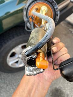 Taking a closer look at the old fuel pump's bent bracket.