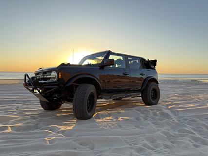 Ford Bronco on beach with top down