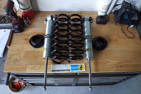 Bilstein_6112_shocks_springs_on_workbench_with_screws