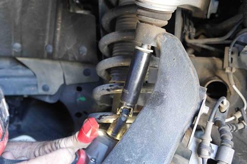 Bilstein_removing_bolt_from_knuckle_upper_control_arm