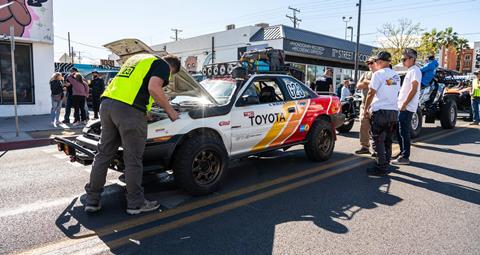 Tech Inspector looking under the hood of the Corolla GT-S during Mint 400 tech day.