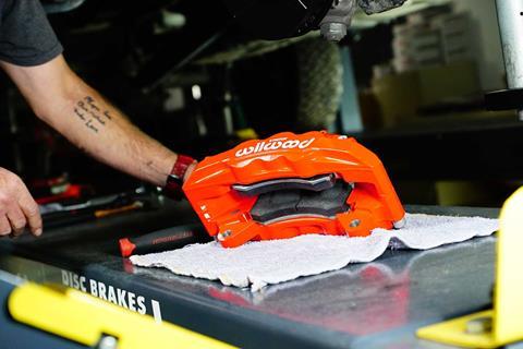 Forged aluminum four-piston Wilwood caliper for Sprinter 2500 AWD brake upgrade getting ready for installation