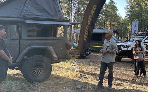Fireside_Todd_Rogerd inspecting vehicle at Hankook Camp Dynapro Overland Expo West 2026